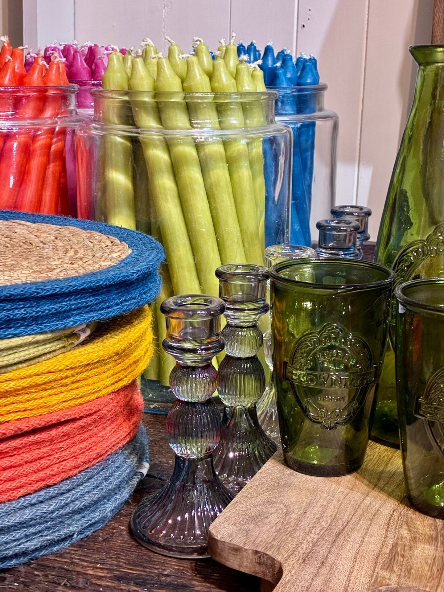 A selection of brightly coloured homewares including candles, placemats and glassware Used in the cookery school The Cook's Place in Malton.
